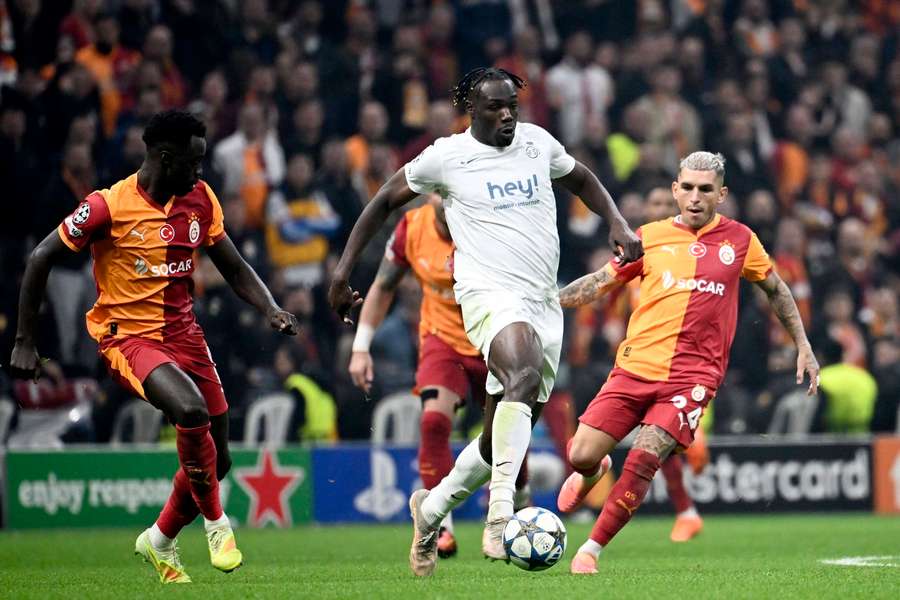 Sanchez Davinson of Galatasaray and Promise David of Royale Union Saint-Gilloise battle for the ball at Rams Park