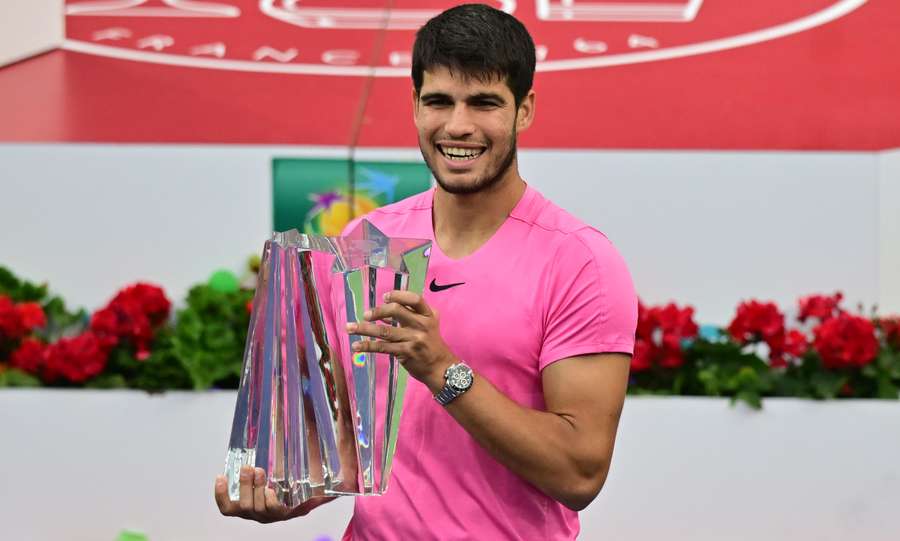 Carlos Alcaraz of Spain holds the championship trophy after defeating Daniil Medvedev of Russia