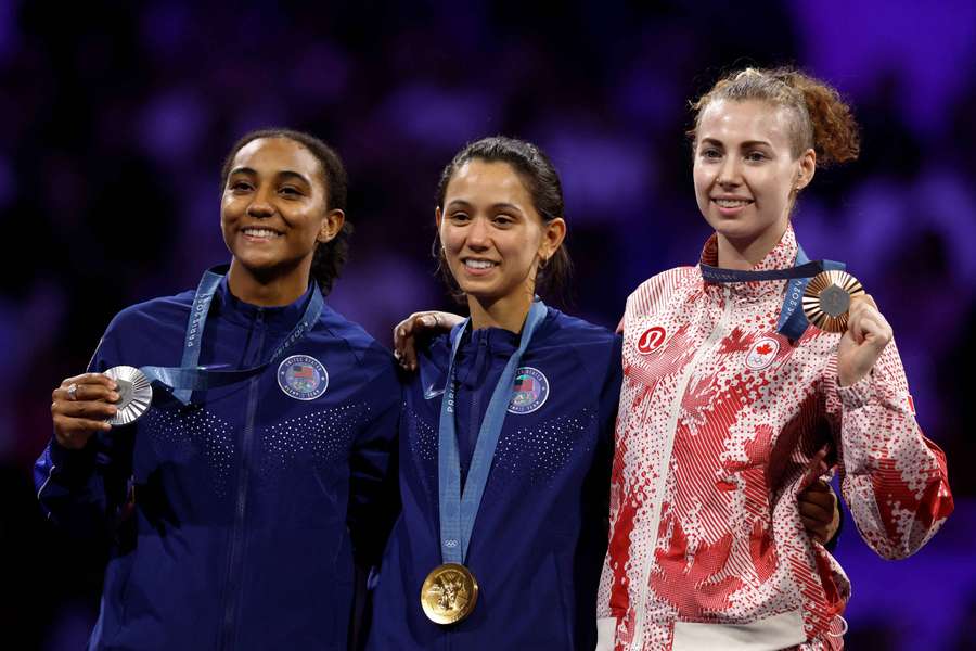 Gold medalist Lee Kiefer of United States celebrates with silver medalist Lauren Scruggs of United States and bronze medalist Eleanor Harvey