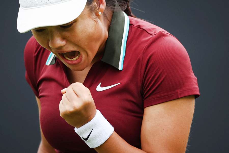 Britain's Emma Raducanu celebrates after winning a point against Ann Li