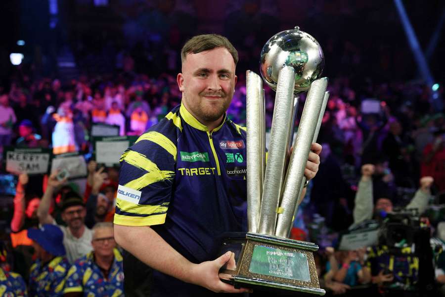 Littler poses with the World Darts Championship trophy Littler poses with the World Darts Championship trophy