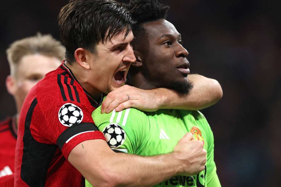 Harry Maguire celebrates with Andre Onana who saved a last-minute penalty against FC Copenhagen