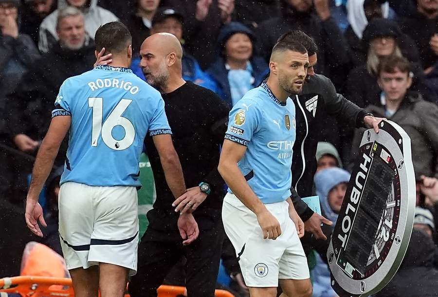 Guardiola and Rodri converse