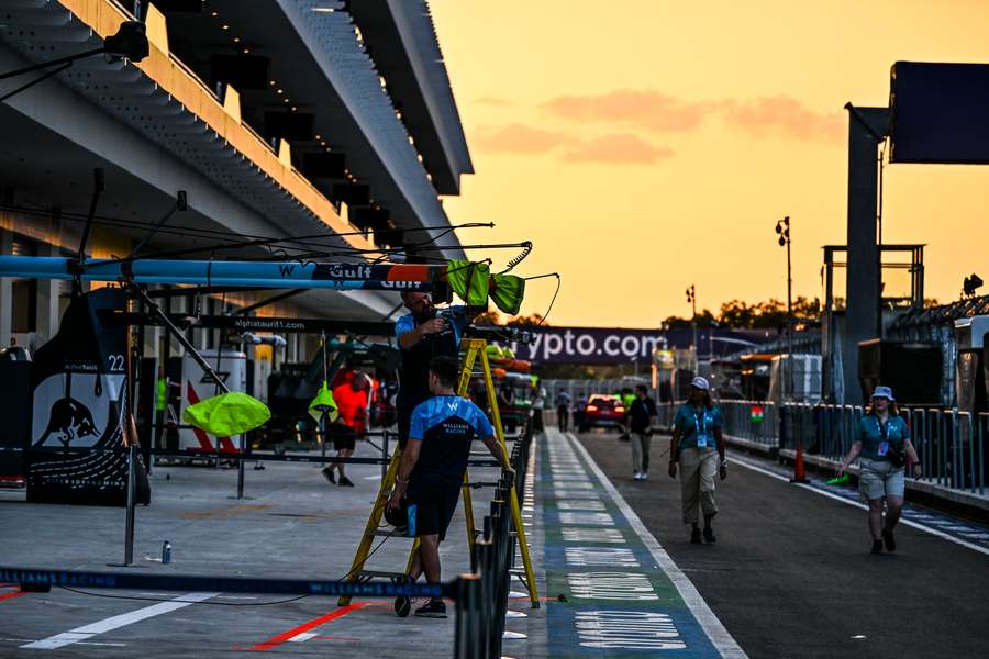 Technicians work in the pit lane ahead of the Miami GP