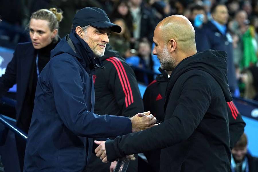 Tuchel (L) shakes hands with Guardiola (R)