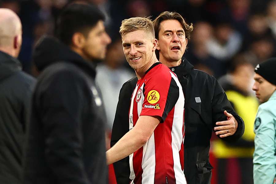 Brentford's English defender #16 Ben Mee smiles as he leaves the pitch having received a red card