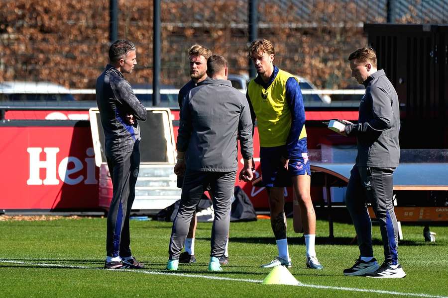 Feyenoord Luciano Valente (2-R) holds his leg as he's forced to leave Tuesday's training session