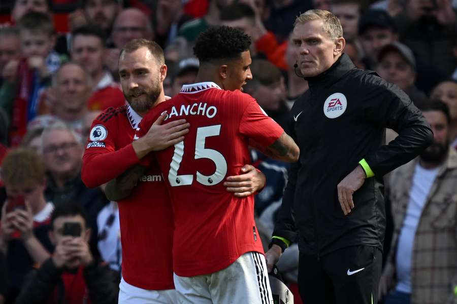 Manchester United's English striker Jadon Sancho leaves the pitch after being substituted off for returning Danish midfielder Christian Eriksen