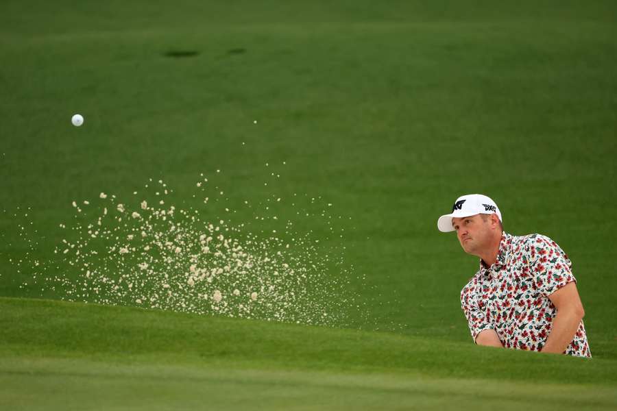 Jason Kokrak plays a shot from a bunker on the second hole