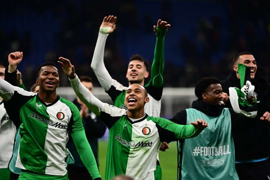 Feyenoord players celebrate their knock-out win over AC Milan at the San Siro