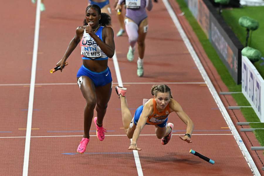 Alexis Holmes runs past Netherlands' Femke Bol who fell before the finish line