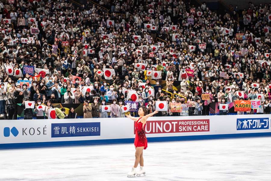 Japan's Kaori Sakamoto gestures to spectators