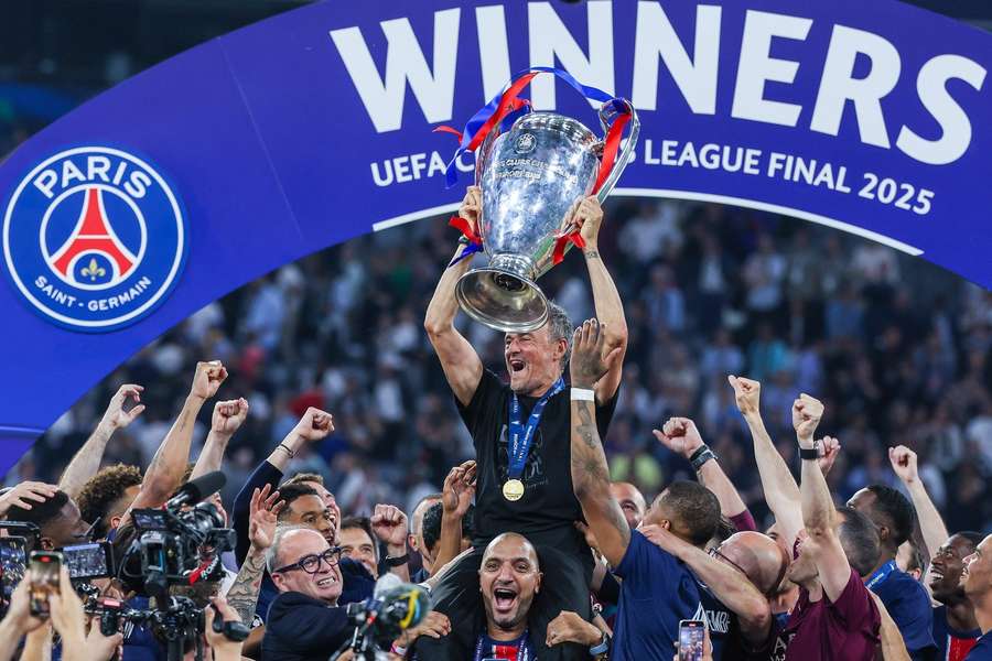 Paris Saint-Germain head coach Luis Enrique lifts the trophy and celebrates winning the 2025 Champions League final