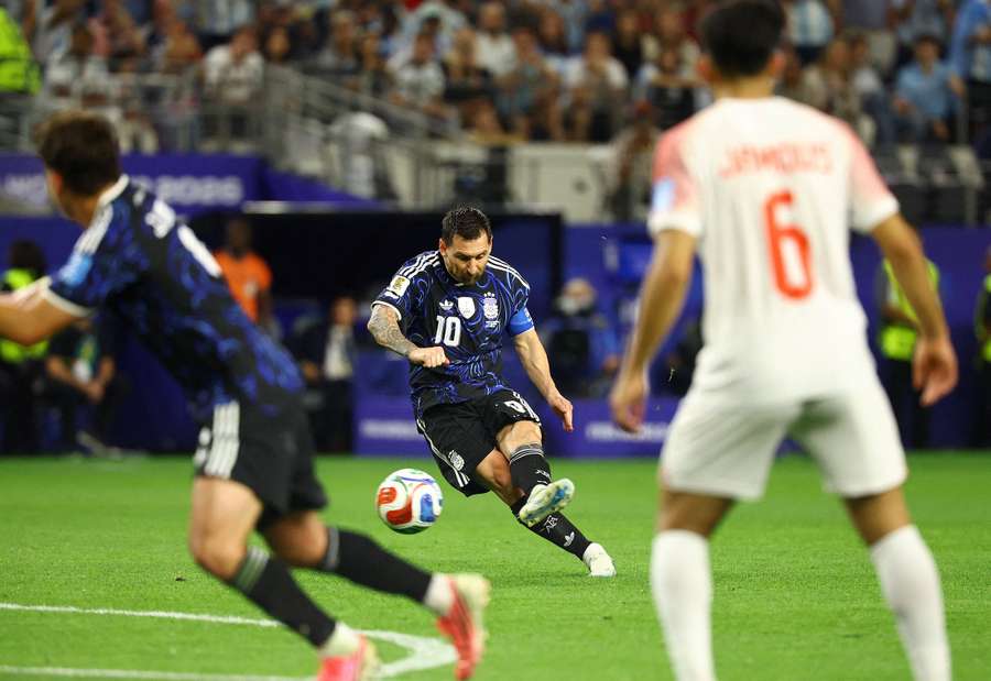 Argentina's Lionel Messi scores from a free kick against Jordan
