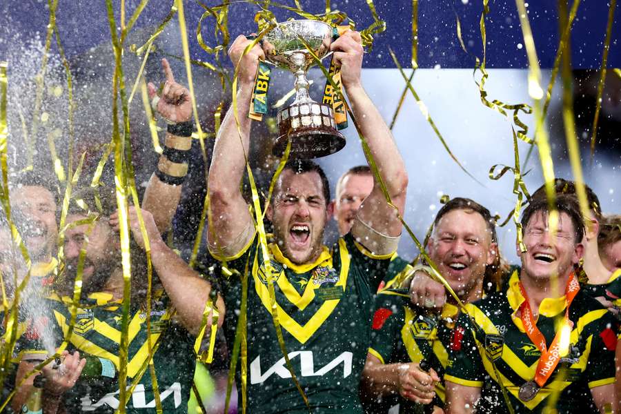 Australia captain Isaah Yeo lifts the trophy with his teammates after the third Test.