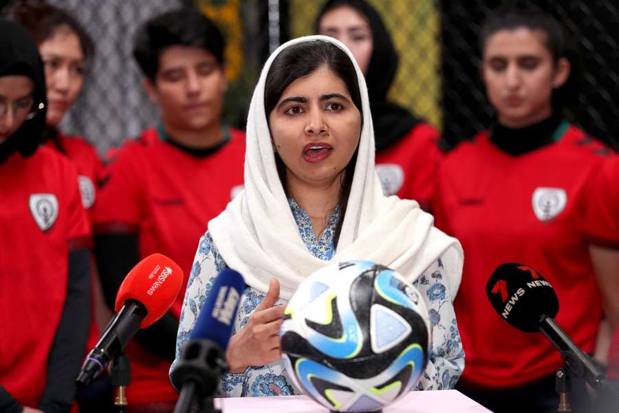 Nobel Prize laureate Malala Yousafzai speaks to the media with the Afghan women's football team in Melbourne.