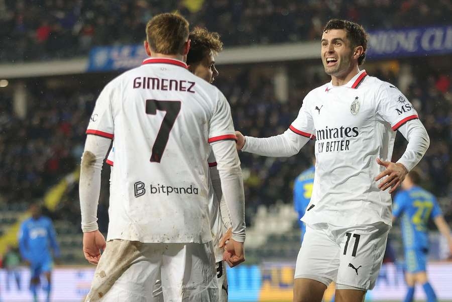 Gimenez (left) celebrates scoring for AC Milan