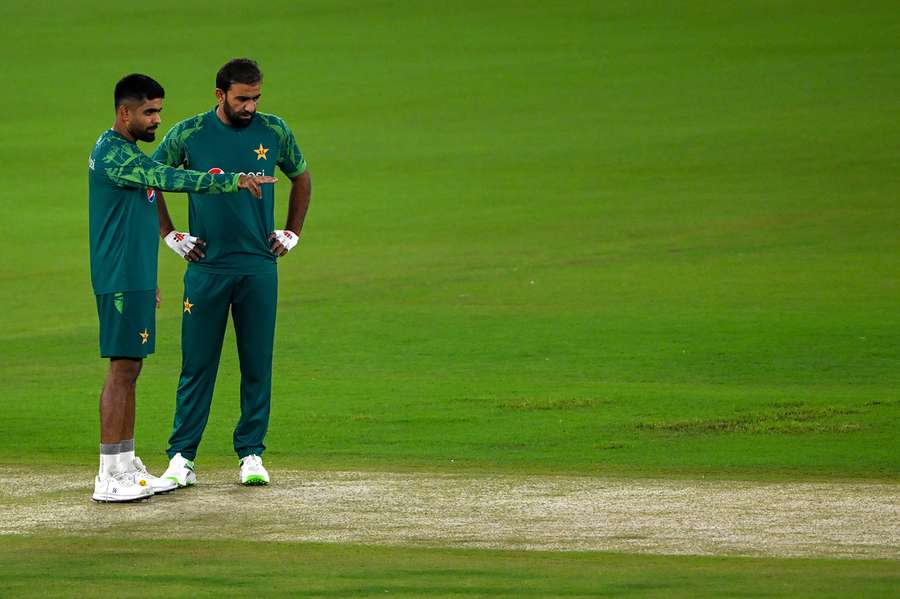 Captain Babar Azam (L) and Iftikhar Ahmed view the pitch ahead of their match against India