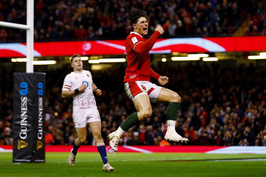 Louis Rees-Zammit celebrates scoring a try for Wales