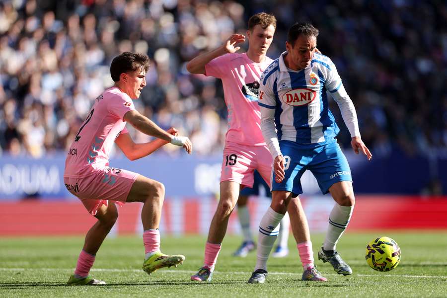 Kike of Espanyol is challenged by Javi Rodriguez and Williot Swedberg of Celta Vigo