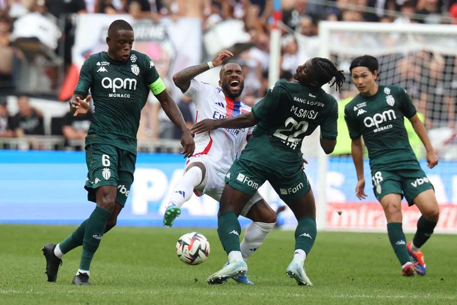 Lyon's Alexandre Lacazette (centre) and Monaco's Mohammed Salisu fight for the ball