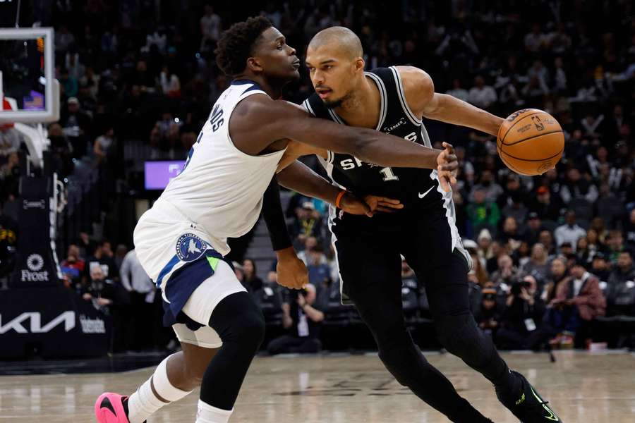 Timberwolves' Anthony Edwards guards Spurs' Victory Wembanyama