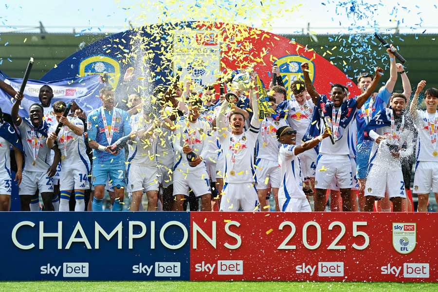 Ethan Ampadu lifts the Championship trophy after Leeds' 2-1 win over Plymouth on Saturday