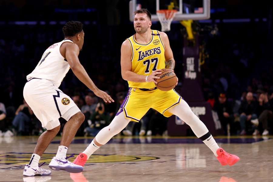 Luka Doncic of the Los Angeles Lakers steps back to shoot against Jalen Pickett of the Denver Nuggets