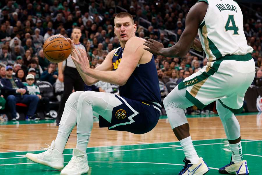 Nikola Jokic (L) scored 34 points as the Denver Nuggets ended Boston's 20-game unbeaten home record in the NBA