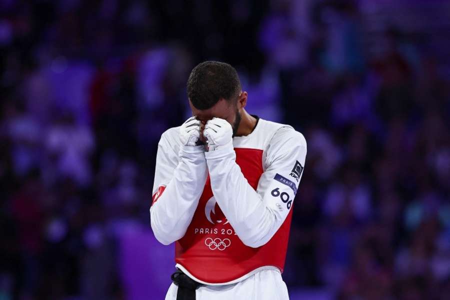 Firas Katoussi of Tunisia reacts after winning his bout against Mehran Barkhordari of Iran