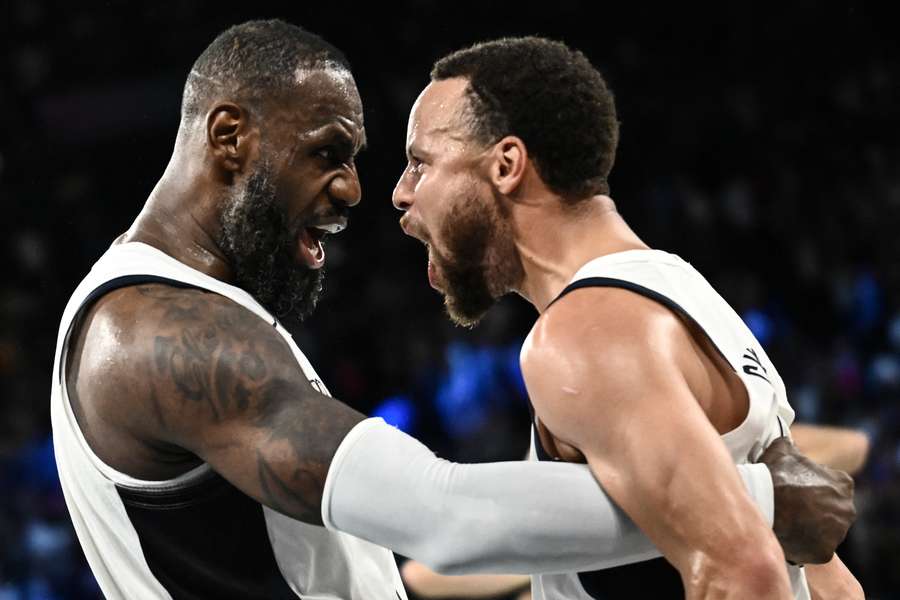 LeBron James (left) celebrates with Stephen Curry at the end of the semi-final between the USA and Serbia