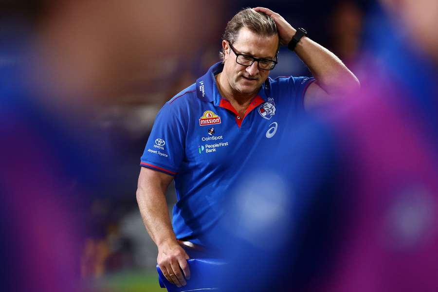 A disconsolate Luke Beveridge looks down after the Bulldogs lost to Brisbane last week.