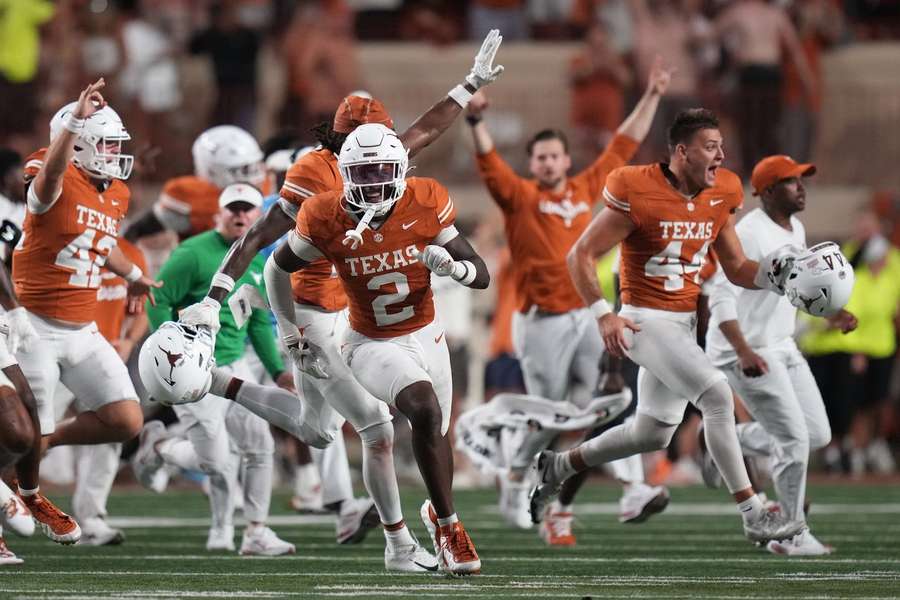 Texas players and coaches rush the field after upsetting Ohio State Texas players and coaches rush the field after upsetting Ohio State