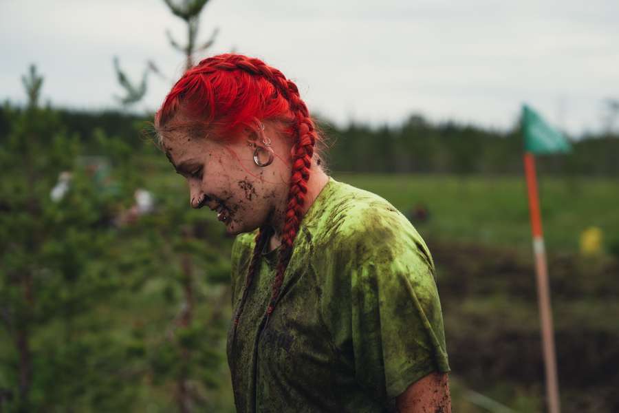 A player's face is covered in mud after a match of swamp soccer during the Swamp Soccer World Cup