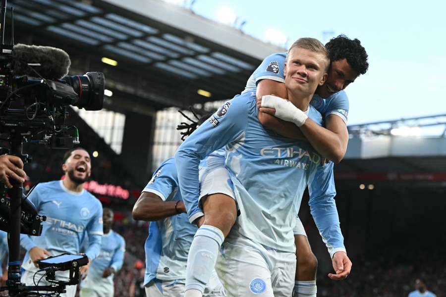 Erling Haaland celebrates with Matheus Nunes after scoring the opening goal against Liverpool