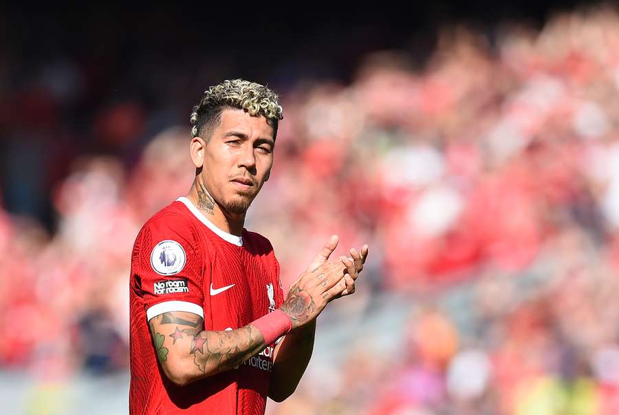 Liverpool's Brazilian striker Roberto Firmino applauds the fans for the last time at Anfield following the English Premier League football match between Liverpool and Aston Villa