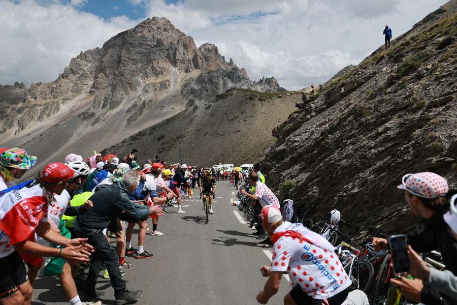General view of cyclists in action as spectators cheer during stage 20 of the Tour de France General view of cyclists in action as spectators cheer during stage 20 of the Tour de France