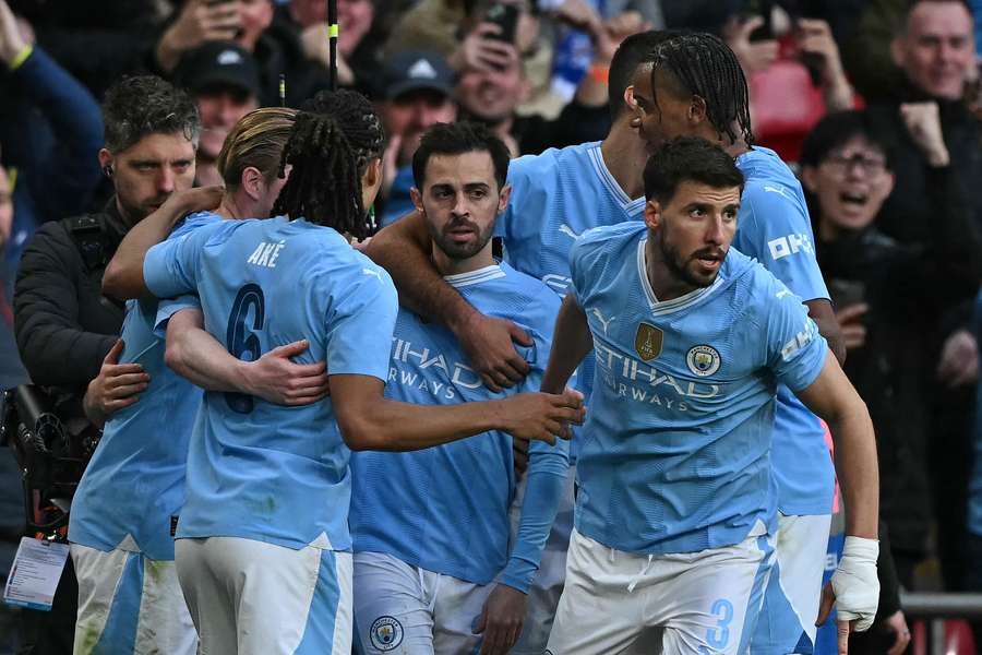 Manchester City's Portuguese midfielder #20 Bernardo Silva (C) celebrates with teammates after scoring the opening goal