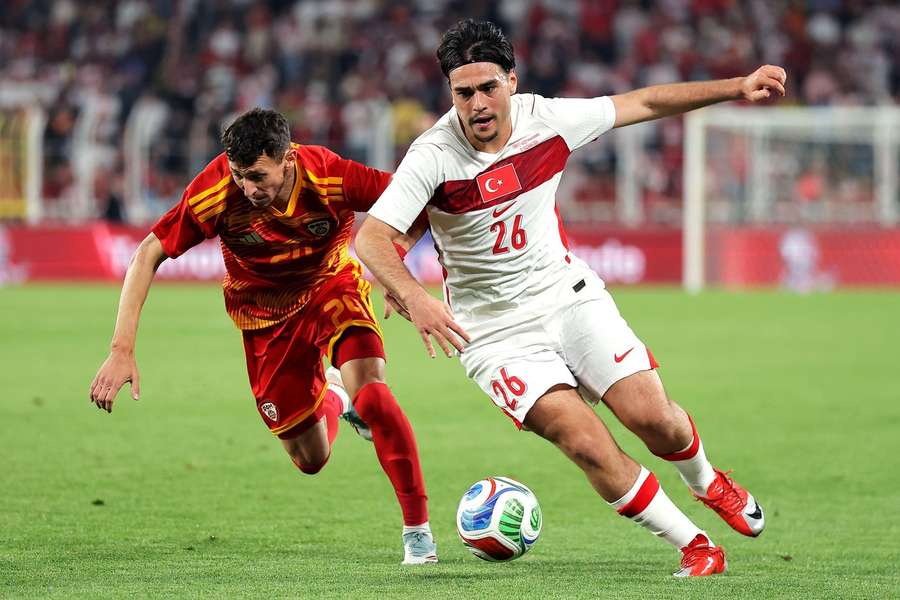 North Macedonia's Darko Dodev and Turkey's Aral Simsir battle for possession in an international friendly North Macedonia's Darko Dodev and Turkey's Aral Simsir battle for possession in an international friendly