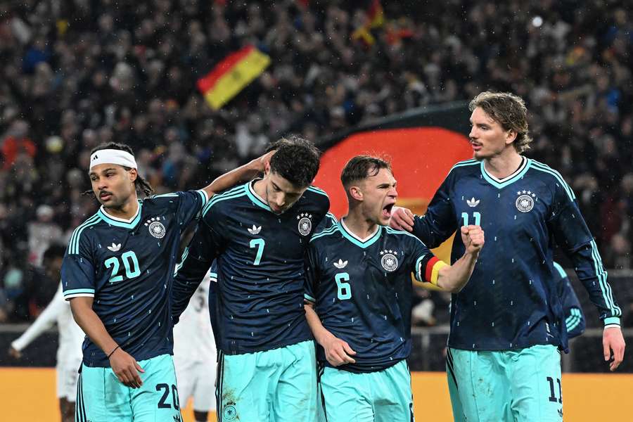 Players celebrate their team's first goal scored by Havertz during the international friendly football match between Germany and Ghana in Stuttgart
