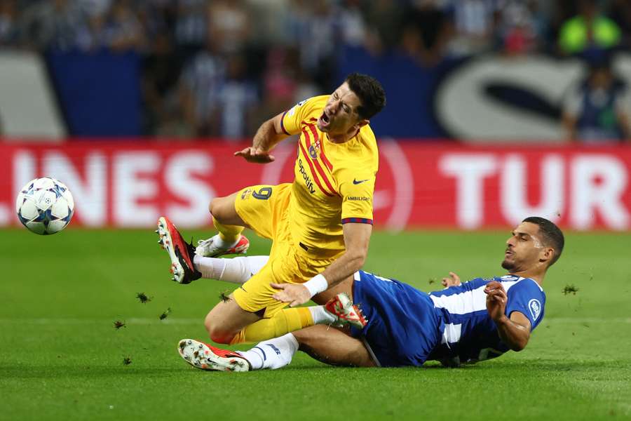 Robert Lewandowski is tackled by David Carmo during Barcelona and Porto's Champions League tie