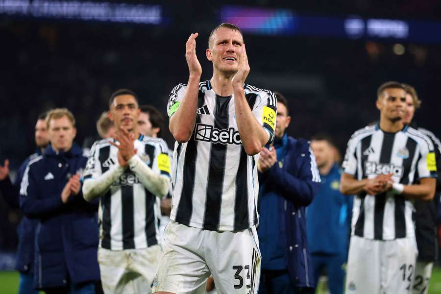 Newcastle United's Dan Burn applauds fans