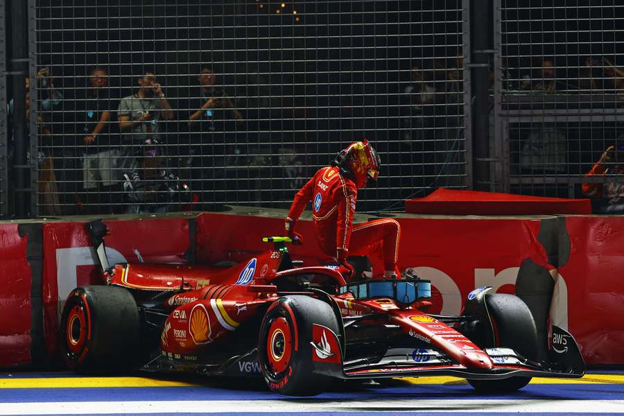 Carlos Sainz climbs out of his car after crashing during qualifying ahead of the Singapore Grand Prix