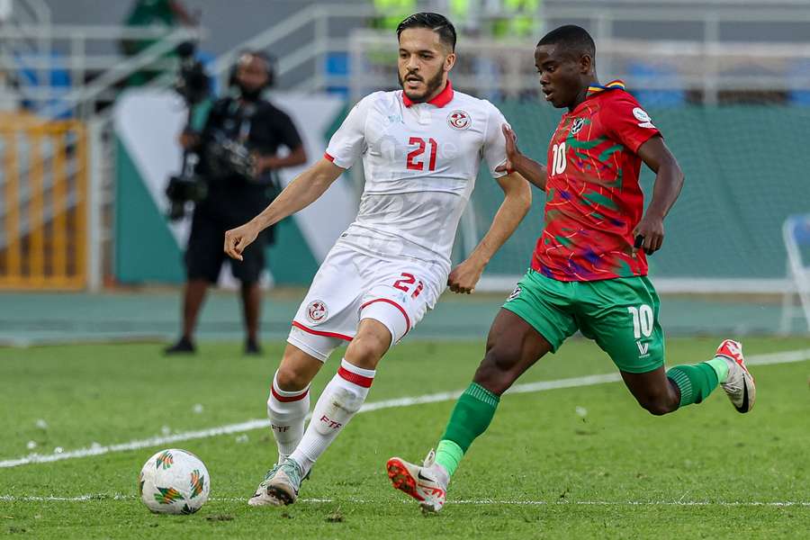 Tunisia's Wajdi Kechrida (L) fights for the ball with Namibia's Prins Tjiueza