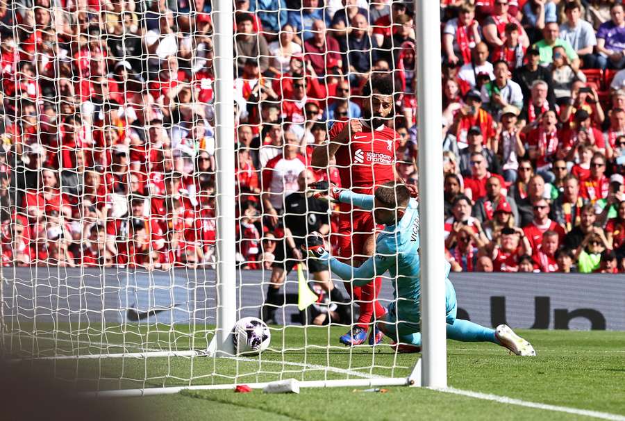 Liverpool's Egyptian striker #11 Mohamed Salah scores the opening goal