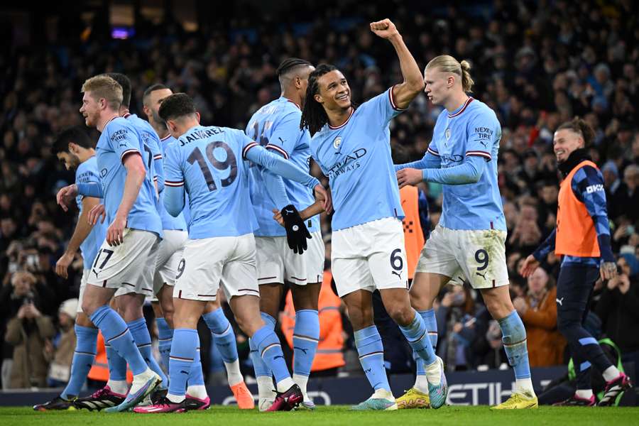 Manchester City's Dutch defender Nathan Ake (C-R) celebrates with teammates