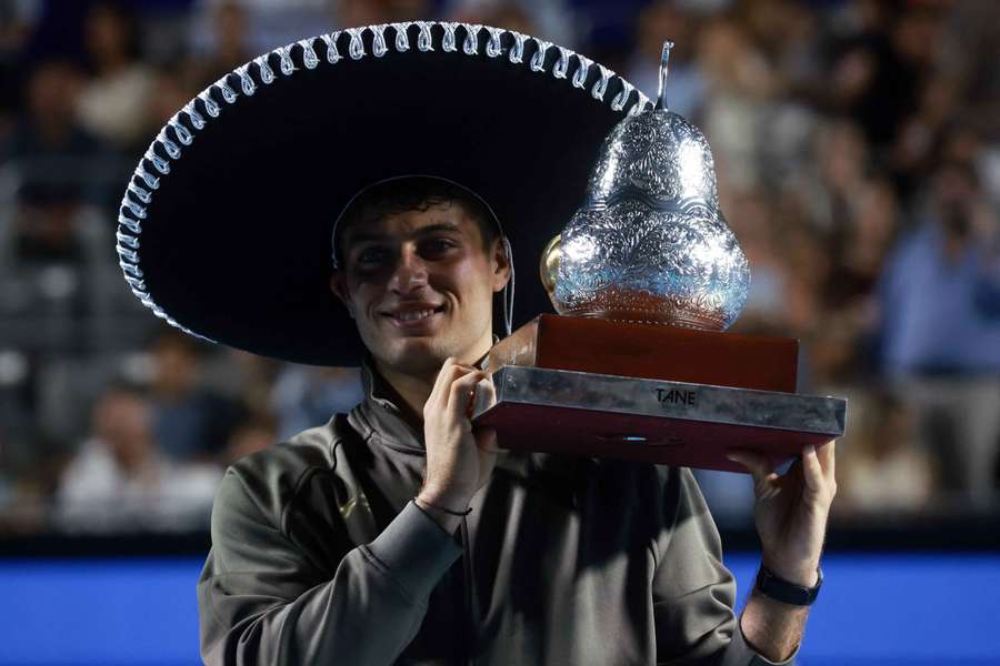 Flavio Cobolli poses with the trophy after winning his final match against Frances Tiafoe