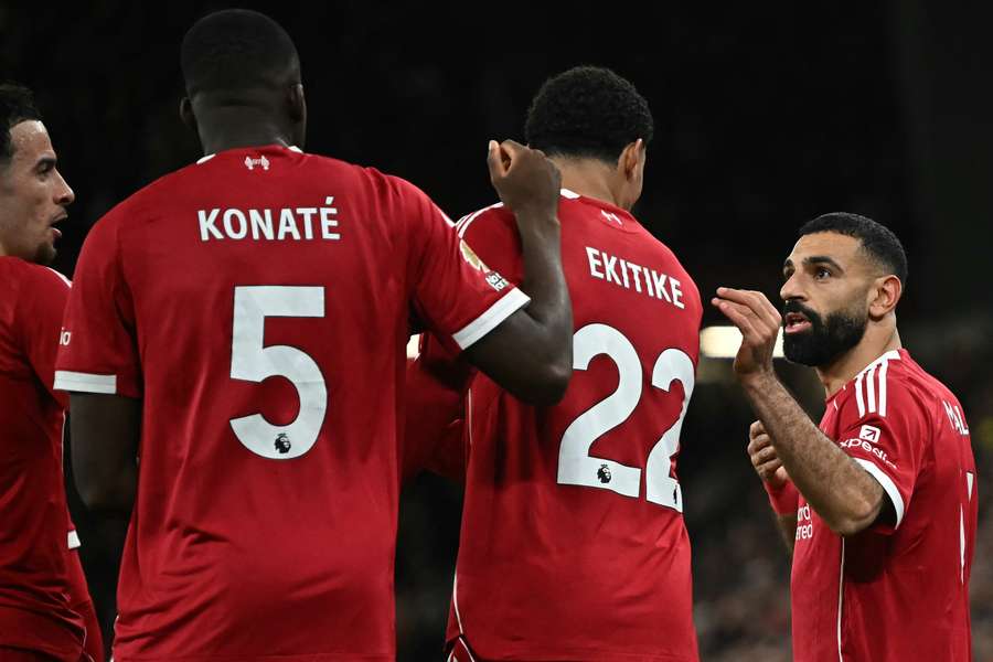 Mohamed Salah (R) talks to Liverpool's French striker #22 Hugo Ekitike (2R) after their second goal Mohamed Salah (R) talks to Liverpool's French striker #22 Hugo Ekitike (2R) after their second goal