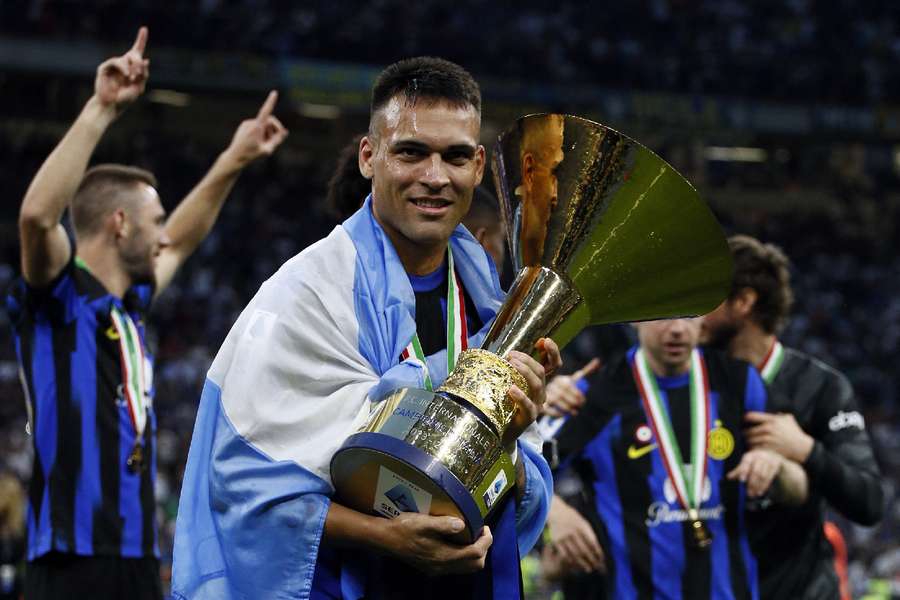 Lautaro Martinez celebrates with the trophy after winning the Serie A