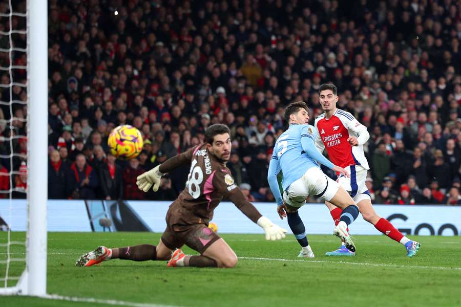 Arsenal's Kai Havertz sees his shot fly past John Stones and hit the back of the net